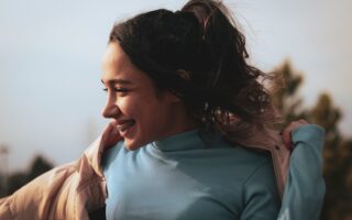 a woman with her hair in the wind