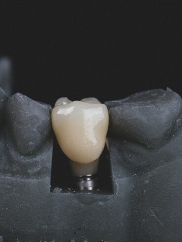 white candle on black textile