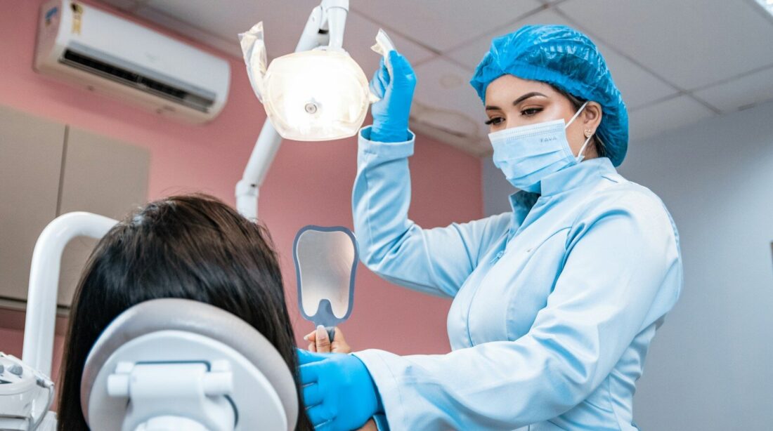 a woman getting her teeth checked by a dentist