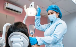 a woman getting her teeth checked by a dentist