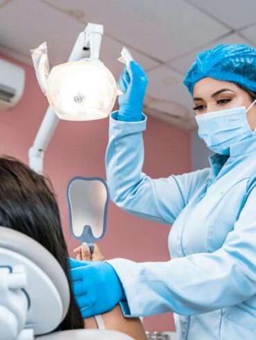 a woman getting her teeth checked by a dentist